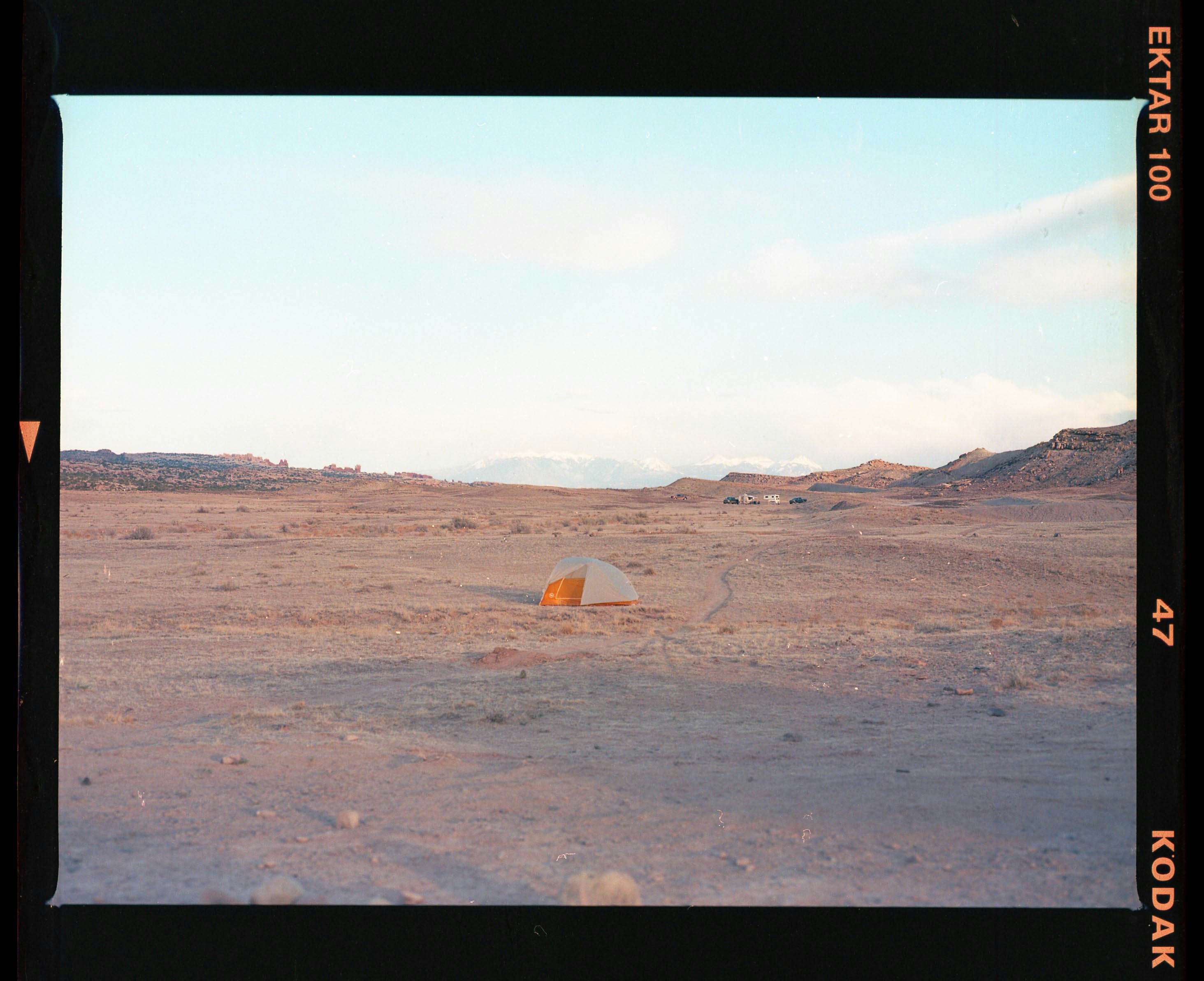 orange tent on brown field during daytime